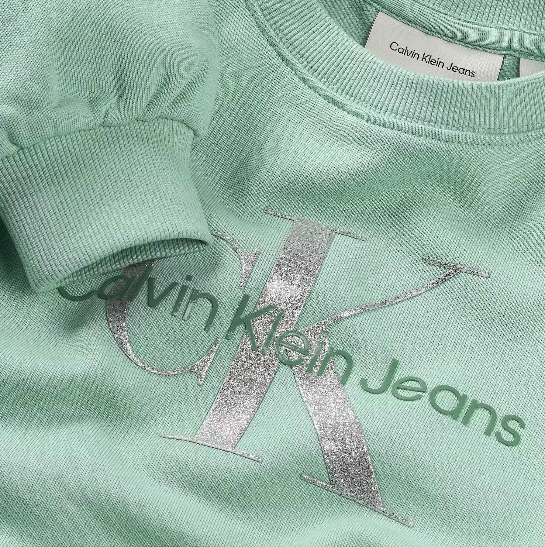 CALVIN KLEIN - GLITTER MONOLOGO CN... CALVIN KLEIN - GLITTER MONOLOGO CN...